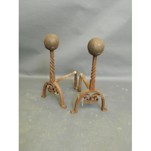 855 - A pair of wrought iron fire dogs with spiral stems and ball finials, 20½