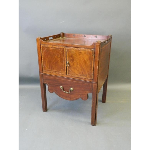 858 - A Georgian commode with pierced gallery top and two cupboards over a pull-out drawer, with all over ... 