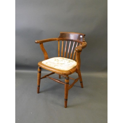 863 - A 1930s beechwood and ash bow desk chair, raised on turned supports with 'H' stretchers