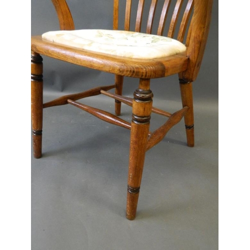 863 - A 1930s beechwood and ash bow desk chair, raised on turned supports with 'H' stretchers