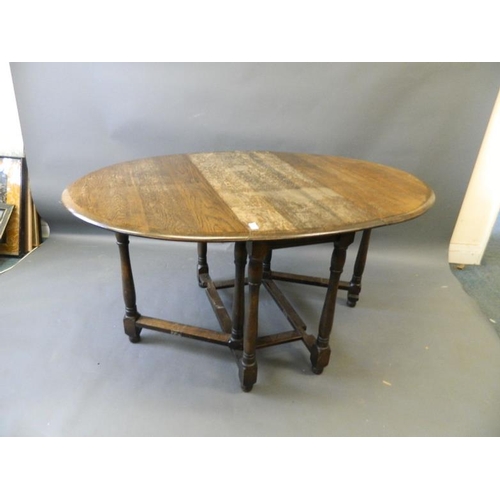 865 - A mid C20th oak drop leaf table on turned supports and gateleg action, 41