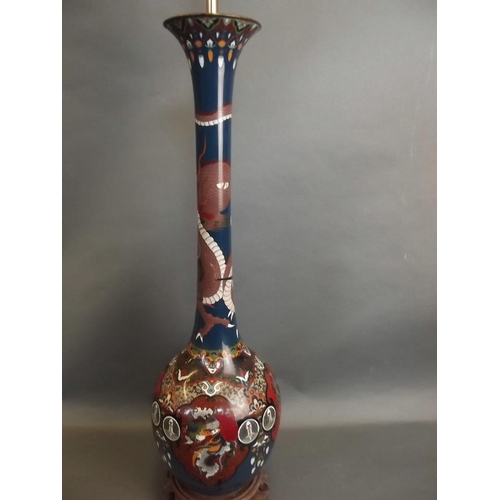 16 - A tall cloisonné bottle neck vase mounted on a carved hardwood base, converted to a lamp, 31