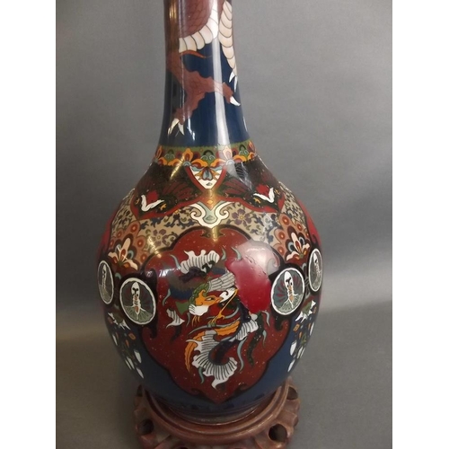 16 - A tall cloisonné bottle neck vase mounted on a carved hardwood base, converted to a lamp, 31