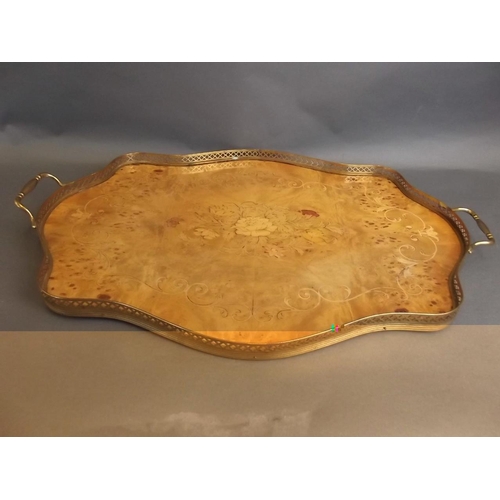 22 - A marquetry inlaid burr walnut serving tray with pierced brass gallery handles, 22