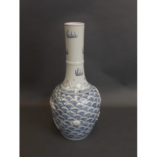 38 - A Chinese porcelain bottle vase with relief dragon and flaming pearl decoration, impressed seal mark... 