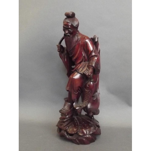 43 - An Oriental rootwood carving of a fisherman with his catch, 12