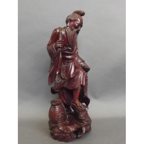 43 - An Oriental rootwood carving of a fisherman with his catch, 12