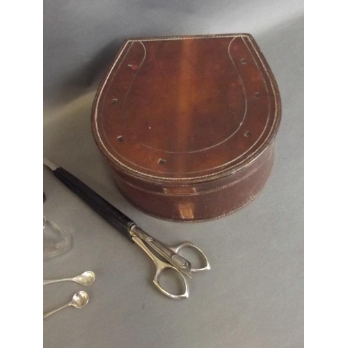 44 - A horseshoe shaped leather collar box, a C19th leather casket shaped box, a glass perfume bottle in ... 