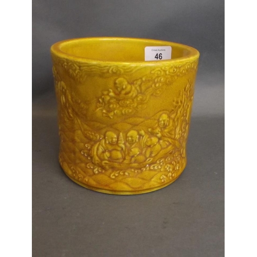 46 - A Chinese mustard yellow crackle glazed brush pot with relief decoration of immortals and their foll... 