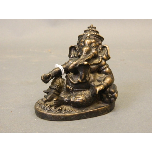 50L - An Oriental bronze figure of Ganesh with a cobra, 3½