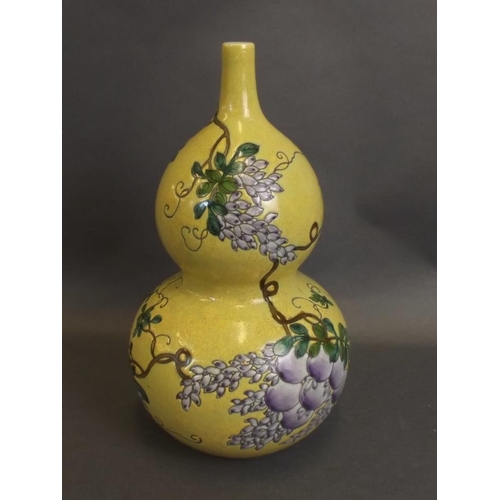 50 - A Chinese yellow ground double gourd porcelain vase with enamelled decoration of a bird perched on f... 