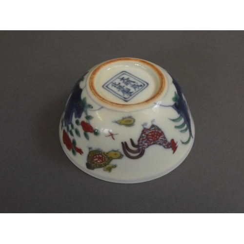 5 - A Chinese Doucai enamel porcelain tea bowl with painted chicken decoration, 6 character mark to base... 