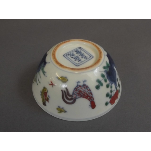 5 - A Chinese Doucai enamel porcelain tea bowl with painted chicken decoration, 6 character mark to base... 