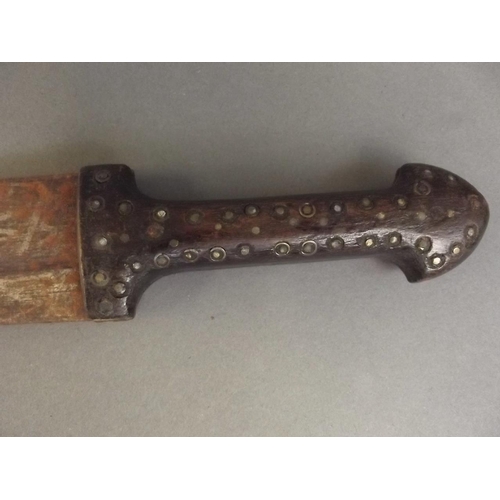 18 - An antique Persian dagger, the hardwood handle decorated with brass studs, the blade etched with Ara... 