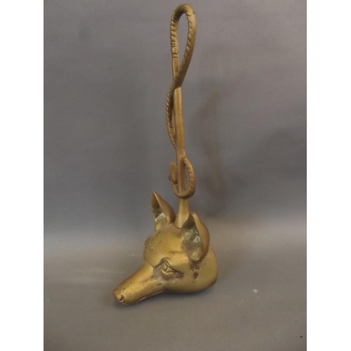 19 - A brass door stop in the form of a fox's head and riding whip, 15