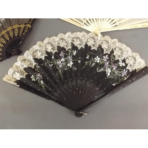 26 - A Victorian bone and lace fan with painted floral decoration, an ebonised and lace fan, and another ... 