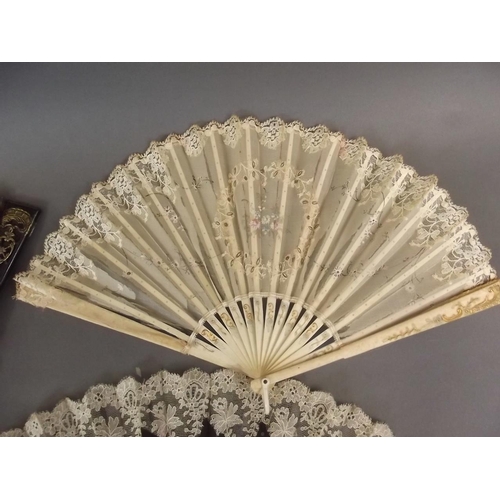 26 - A Victorian bone and lace fan with painted floral decoration, an ebonised and lace fan, and another ... 