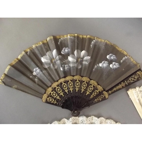 26 - A Victorian bone and lace fan with painted floral decoration, an ebonised and lace fan, and another ... 