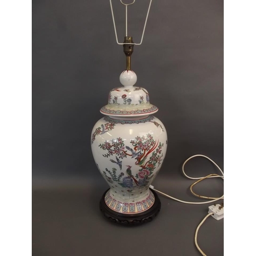 33 - A large Oriental porcelain baluster vase shaped lamp base, on a carved wood stand, 24