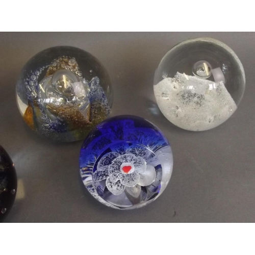 50E - A collection of six Caithness Art glass paperweights including the designs 'Titania', 'Tidal Wave', ... 