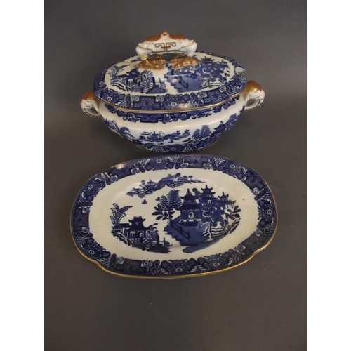 9 - A Royal Worcester blue and white 'Willow' pattern sauce tureen with lid and stand, with gilt embelli... 