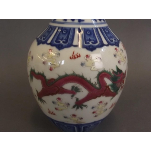 24 - A Chinese blue and white porcelain vase with painted green and puce enamel twin dragon decoration, s... 