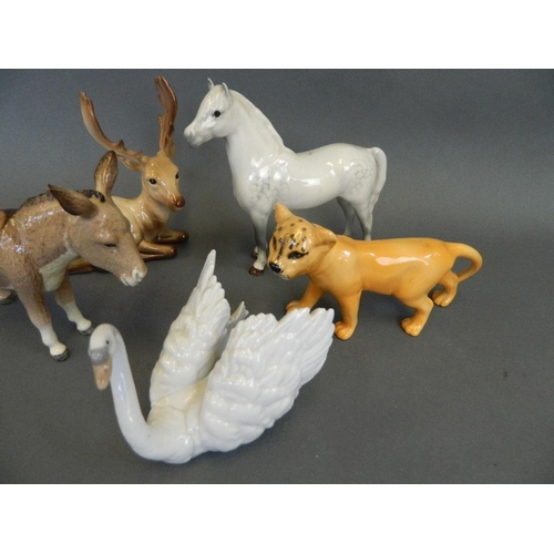 28 - A Beswick porcelain figure of a donkey, a Beswick Welsh grey figure of a pony, a Lladro porcelain fi... 