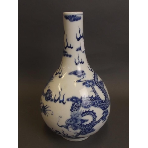 4 - A Chinese blue and white porcelain bottle vase with painted decoration of dragons chasing the flamin... 