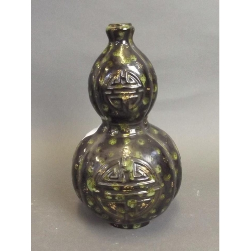 37 - A Chinese Jun ware black ground double gourd stem vase with green and gilt splash glaze and raised  ... 