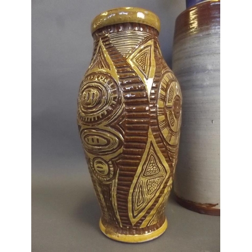 38 - An art pottery cylindrical vase with flared neck, together with a studio pottery baluster vase with ... 