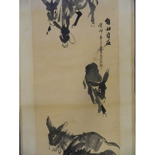 42 - A Chinese monotone watercolour scroll depicting donkeys grazing, 18