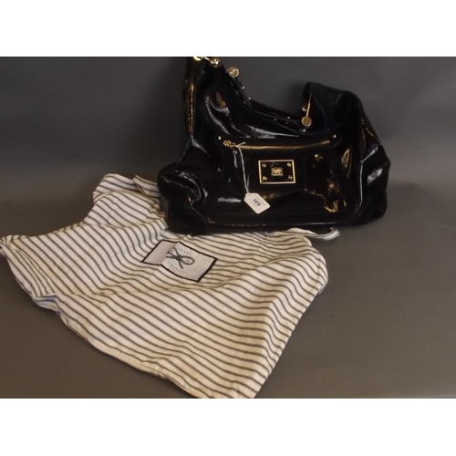 50S - A black leather designer handbag by Anya Hindmarch of London, together with a branded tote carry bag... 