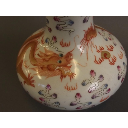 8 - A Chinese porcelain squat vase with painted enamel red dragon and flaming pearl decoration, with gil... 