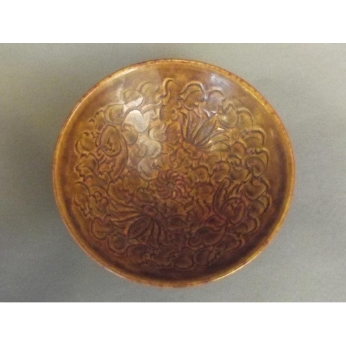 20 - A Chinese Jizhou kiln ochre glazed bowl with chased decoration of a boy and lotus flower, 6½