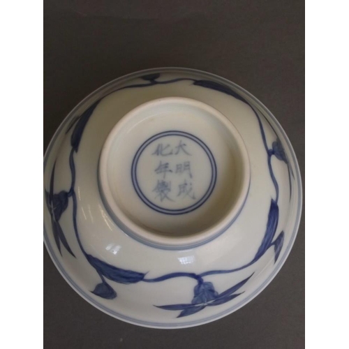 25 - A Chinese blue and white porcelain rice bowl with foliate decoration, 6 character mark to base, 6