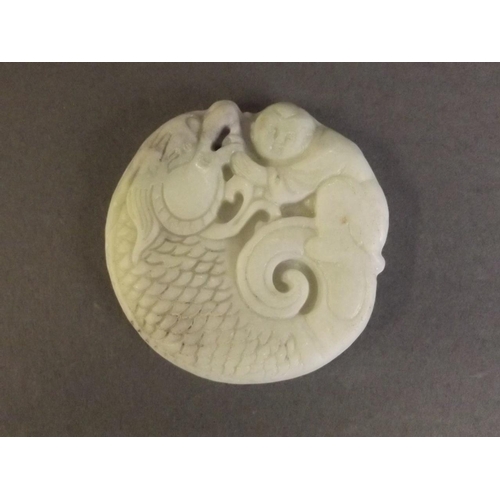 28 - A Chinese white jade pendant carved as a dragon and child, 2