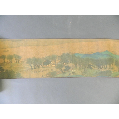 38 - A Chinese printed scroll depicting an extensive landscape with temple complexes, palaces, villages a... 