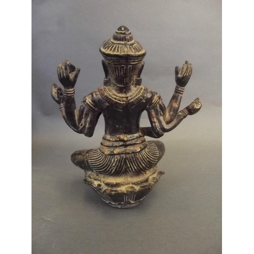 39 - An Oriental bronze figure of a six armed deity seated in the lotus position, on a lotus throne, 8