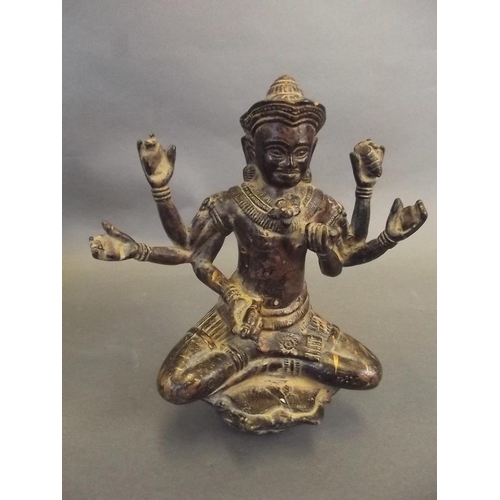 39 - An Oriental bronze figure of a six armed deity seated in the lotus position, on a lotus throne, 8