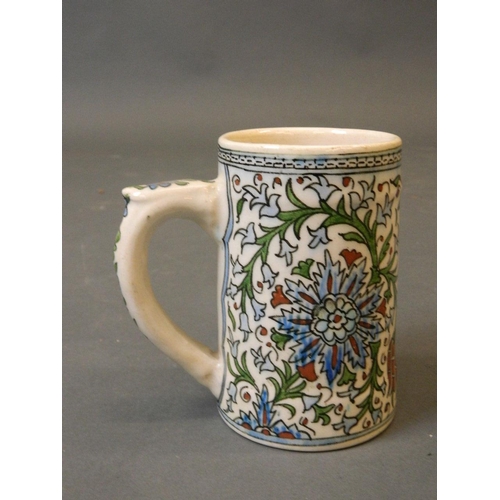 50F - A glazed earthenware tankard with Iznik decoration, possibly early C20th, 5½