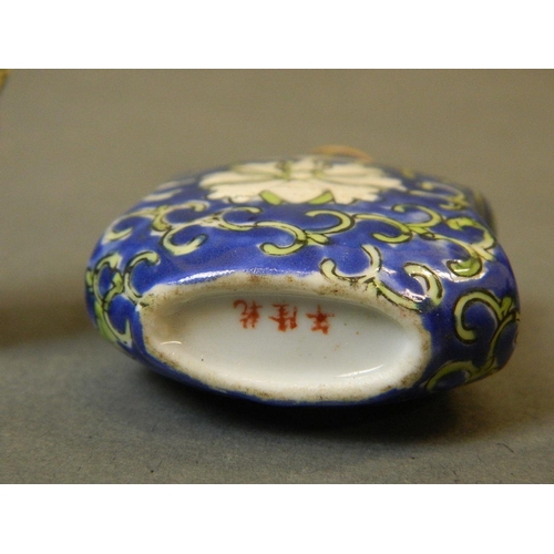 50J - A Chinese porcelain snuff bottle of waisted form with enamel glaze and stylised lotus decoration, 3 ... 