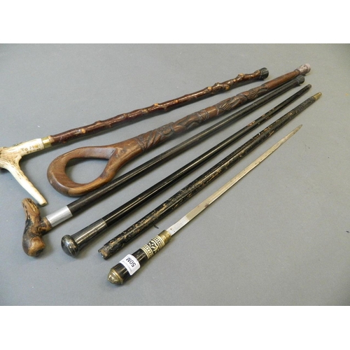 50M - An Indian bone and brass mounted sword stick, and four other walking sticks