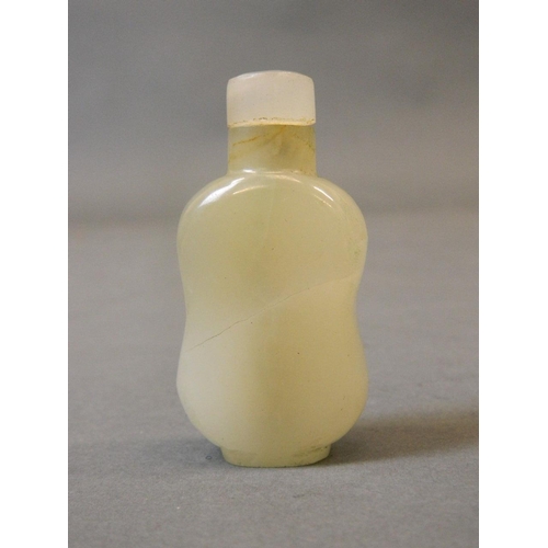 50N - A Chinese carved celadon jade snuff bottle, 2½