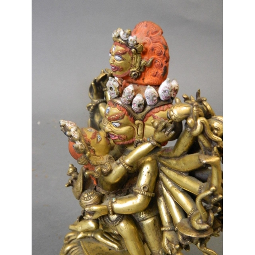 50W - An antique Sino-Tibetan gilt and painted bronze figure of Yamantaka, titular Mahayana deity embracin... 