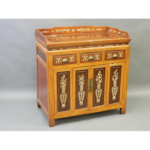 822 - A Chinese fruitwood cabinet with inset hardwood panels and bone inlaid decoration, the three drawers... 