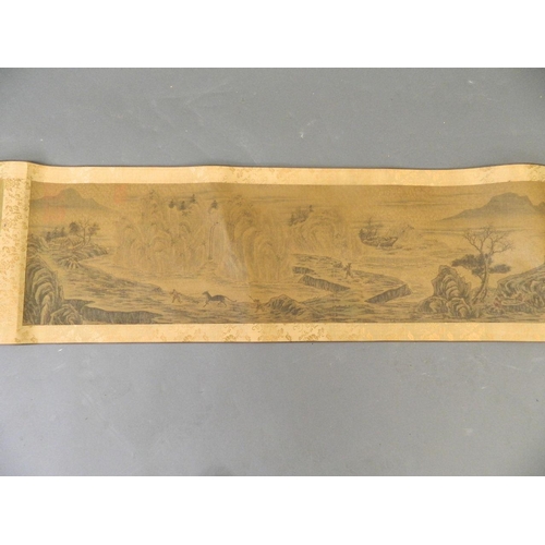 10 - A Chinese printed scroll depicting an extensive landscape with boatmen and riverside villages, with ... 