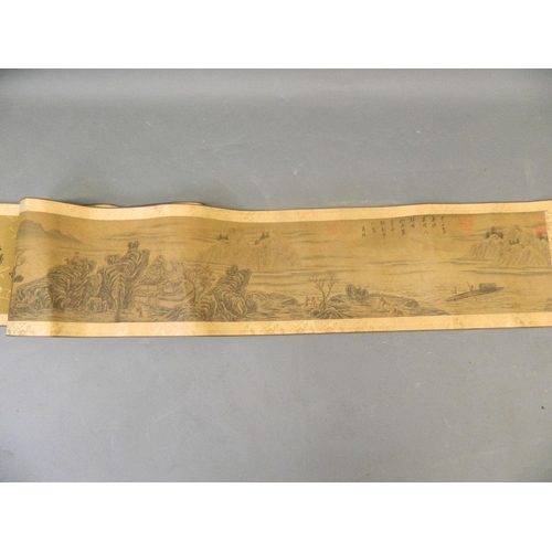 10 - A Chinese printed scroll depicting an extensive landscape with boatmen and riverside villages, with ... 