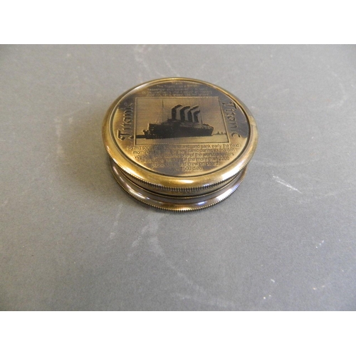 24 - A brass pocket compass with engraved plaque of the Titanic, 2