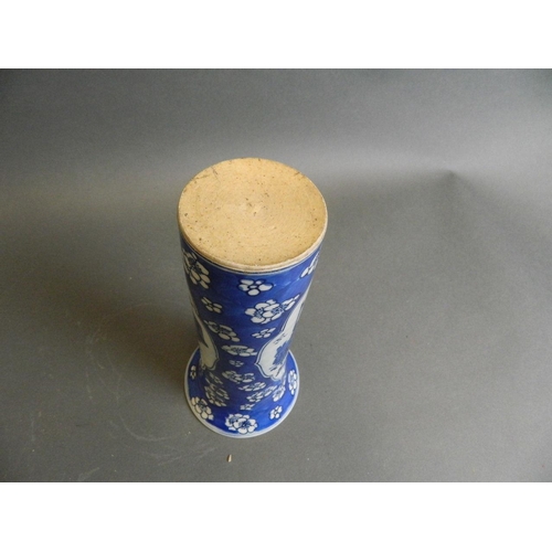 32 - A Chinese blue and white porcelain cylinder vase with decorative panels of precious items on a crack... 