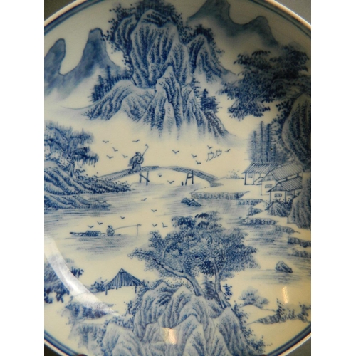 44 - A Chinese blue and white porcelain dish with extensive riverside landscape decoration, 6 character m... 